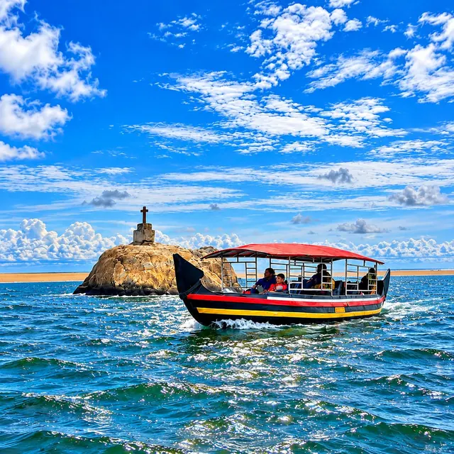 Shikara boat passing the rock with the cross near Poovar beach