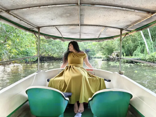 Guest relaxing on a Poovar boat cruise in the mangroves