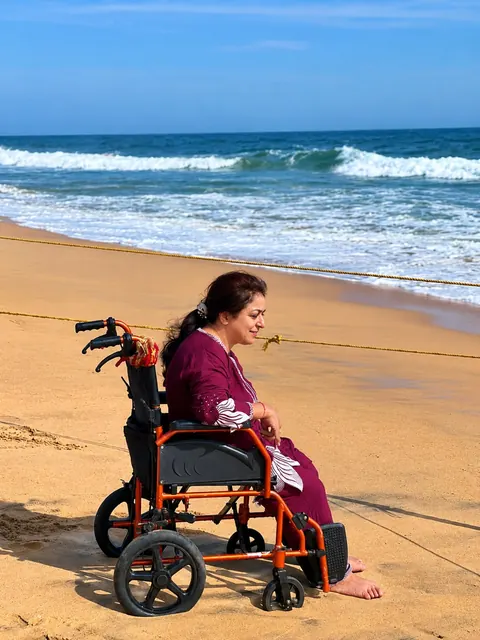 Guest in a wheelchair enjoying Poovar beach