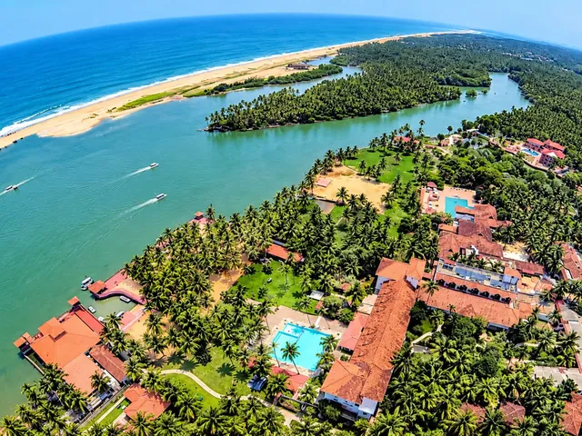 Aerial view of Poovar island – the estuary, golden sand beach, Arabian Sea and backwater boats – Poovar Island Round Cruise