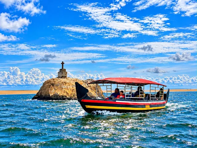 Shikara boat ride past the rock with the cross near Poovar golden sand beach – Shikara Boating in Poovar