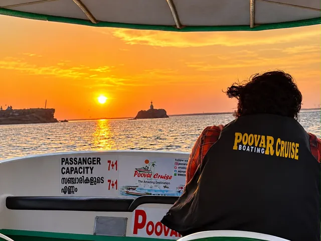 Sunset over the Poovar estuary and the rock with the cross, seen from the Poovar Boating Cruise boat – Sunset Cruise